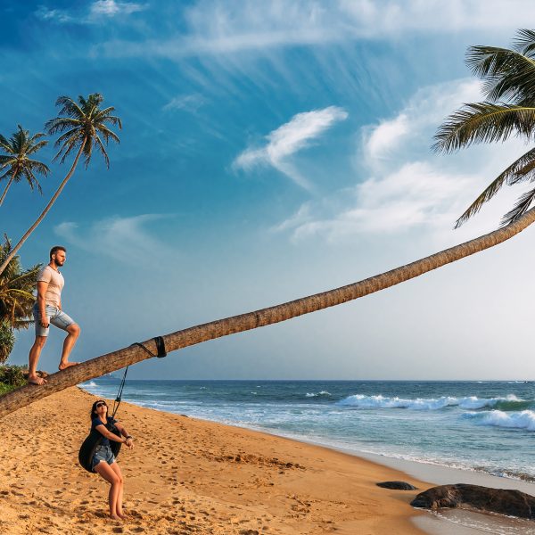 A couple in love meets the sunset on the beach with palm trees. Wedding travel. Guy and girl traveling around Asia. Man and woman resting in Sri Lanka. Couple in love at sunset. Couple on the island
